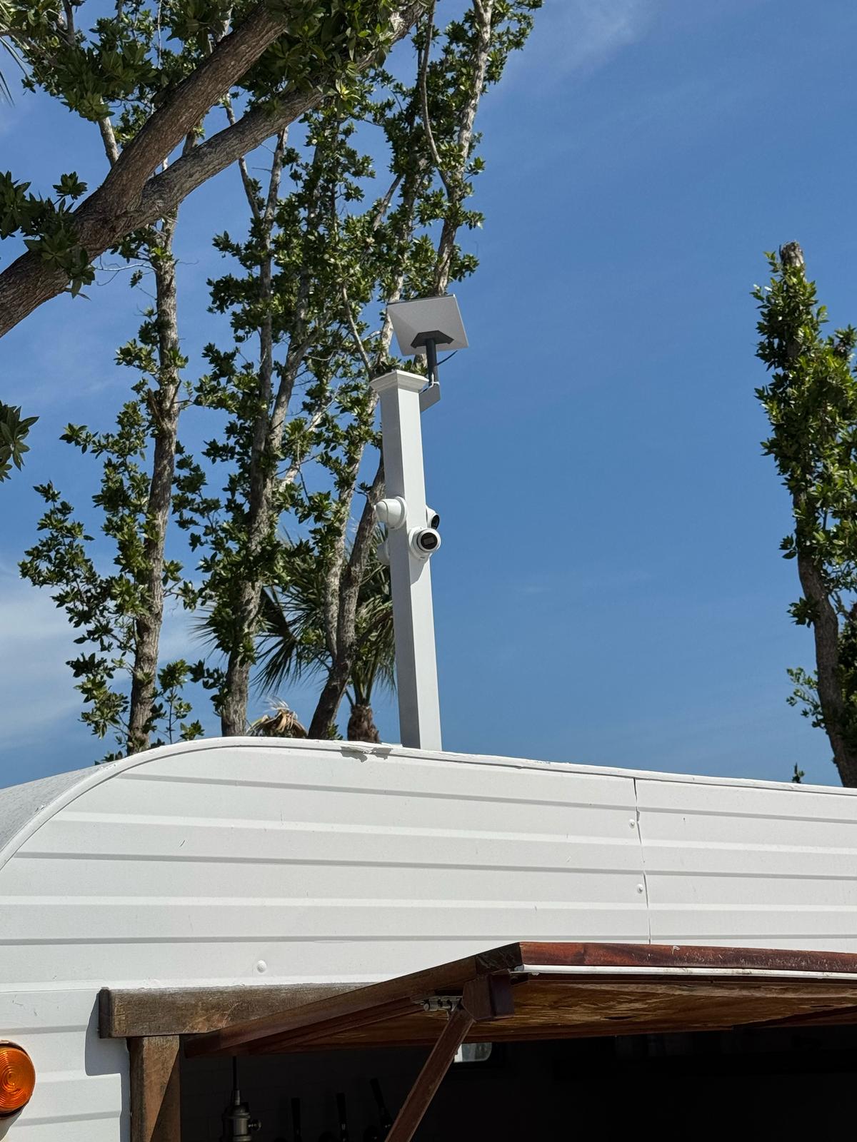 Starlink dish and two cameras on a roof post on a mobile unit